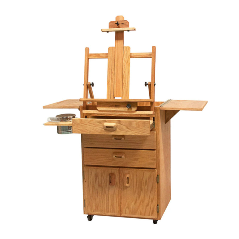 A BEST Sitha Taboret with built-in storage compartments for your art supplies. The BEST Sitha Taboret features a drawer, shelves, and fold-out side panels for additional workspace. It has a sturdy base and locking rubber casters for easy mobility.