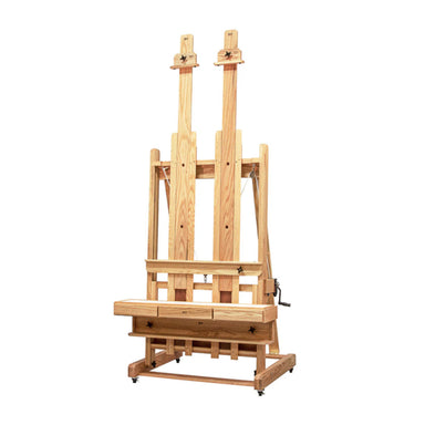 The BEST Abiquiu Deluxe Easel w/ Optional Tray is a large, adjustable wooden easel crafted from hand-rubbed solid oak. It features a rectangular base and two vertical supports for holding canvases, with knobs and screws for adjustments, and wheels at the base for mobility.
