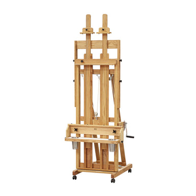 A BEST Classic Santa Fe II Easel by BEST with a sturdy structure and multiple adjustable supports stands on a wheeled base. The easel includes a tray for holding art supplies and features a marine style winch mechanism for height adjustment.